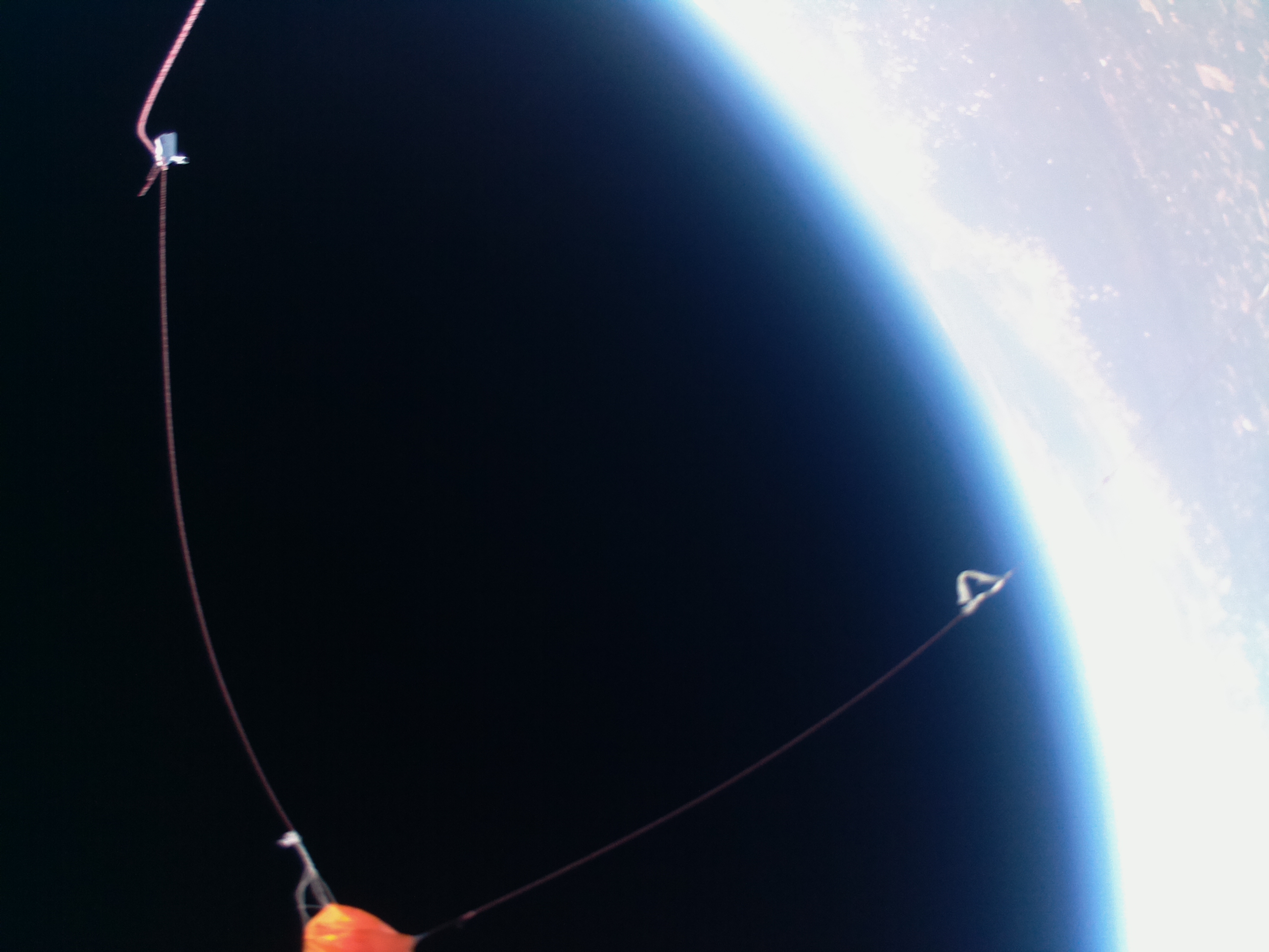 View of balloon remnants, parachute, and K5NSX RS41 tracker shortly after burst